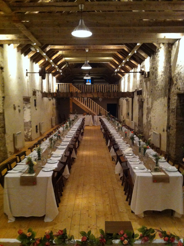 The Barn - long tables laid for reception