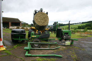 Wrapping large hay bale in the farm yard